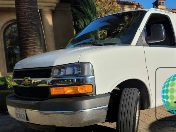 Sam's Carpet Services van parked in a driveway